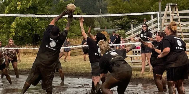 People playing mud volleyball