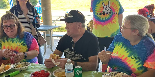 UHI staff and humans at a picnic event