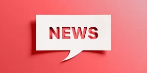 News text cut out of a piece of paper